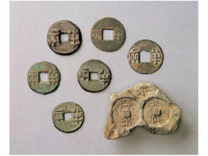 Different currencies from the warring states — knife-money, spade-money, and regional coins, all incompatible
